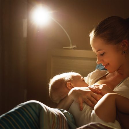 Breastfeeding.,Mother,Feeding,A,Baby,Breast,In,Bed,Dark,Night